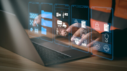 A construction worker sitting at a desk, working on a laptop. The image highlights the integration of technology in construction, focusing on digital tools, safety, and project management.