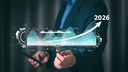 Businessman analyzing financial growth data with futuristic digital graph and rising trend arrow projecting success forecast for 2026, symbolizing business strategy and investment growth.