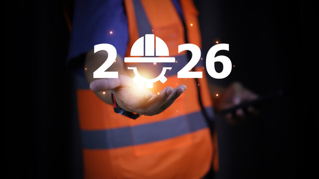 An engineer holding a phone with the year 2026 and a digital safety helmet icon. This image highlights the role of technology and safety in future construction and project management.