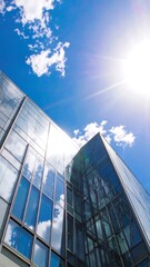 Modern glass building under a vibrant blue sky