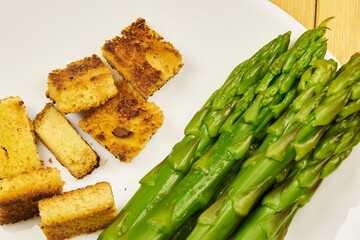 A bowl of asparagus soup in the foreground with rustic decor and background, high studio shots with...