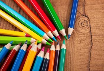Fototapeta premium Vibrant colored pencils arranged artfully on a wooden surface, desk, illustration