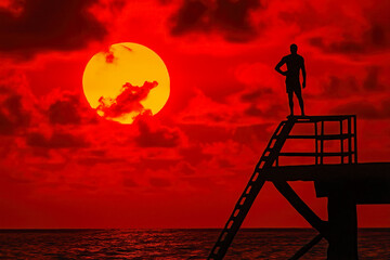 Lifeguard silhouetted against a stunning sunrise or sunset, creating a peaceful yet vigilant atmosphere
