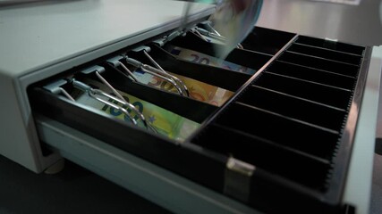 Close up male hands unlock cash register put euro banknotes and take change - Powered by Adobe