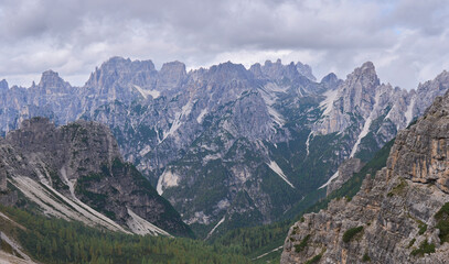 The mountain landscape of inaccessible and wild Friuli Dolomites, UNESCO Heritage. Nature reserves Dolomiti Friulane and Forra del Cellina. Layers of distant mountain ranges. Autumn, mist, rain clouds