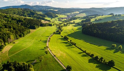 Panoramic view of rolling hills and valleys, lush green fields, and a winding road