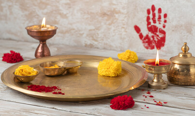 Decorative Platter with Candles and Marigold Flowers Featuring Red Handprint for Diwali Celebration