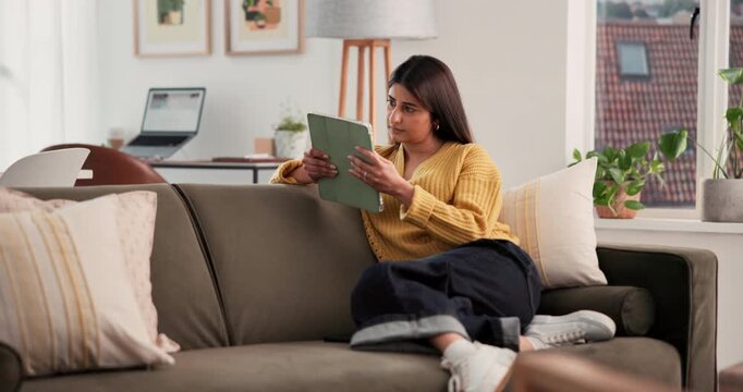 Woman, research and reading with tablet in home for online network service or remote work. Female person, user or freelancer with technology on couch for business schedule, ideas or insight in house