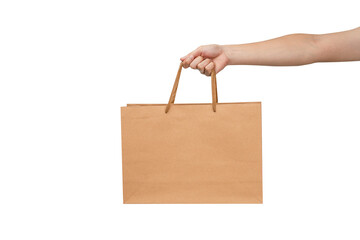 A person's hand holding a paper shopping bag with handles on a clean white background. Studio shot with ample copy space for text, logos, or branding. Isolated on white, cut out.
