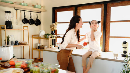 daughter mother kitchen food preparing cooking child bonding happy girl together home parent