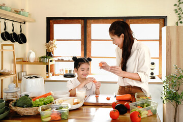 daughter mother kitchen food preparing cooking child bonding happy girl together home parent