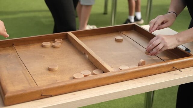 Elastic board game where speed, accuracy and strategic thinking become the keys to victory. Shoot pucks through small gates in the middle of the playing field with the help of a rubber band. 