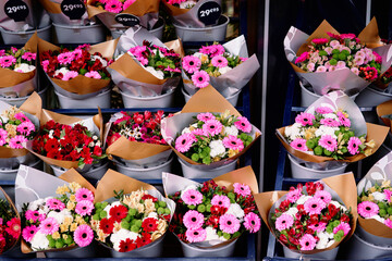Colorful Flower Bouquets Arranged in Buckets at a Market Display