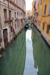 A Venetian canal with a gondola and ancient buildings