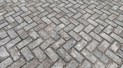Herringbone paving block pattern showing geometric alignment and durable surface structure.
