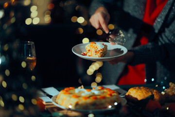 Person Cutting a Boeuf Salad Present at the Christmas Table. Housewife serving the aperitif for the holidays made in Romanian style cuisine
