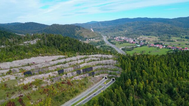 Panoramic aerial view of the toll highway (Autocesta A6) bridge near Fužine (Fuzine) and Lake Bajer in Gorski Kotar, Croatia, surrounded by green mountains and forests