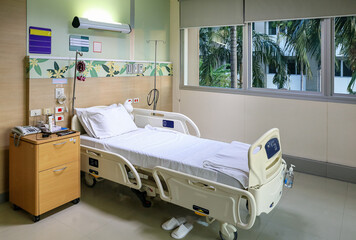 Empty modern adjustable patient bed in recovery room at hospital ward.