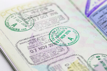 Immigration VISA Stamps on Passport with Shallow focus.