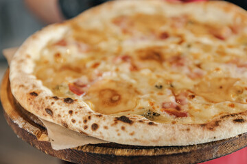 Delicious cheese pizza on wooden plate in cozy pizzeria setting