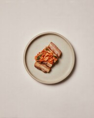 Samgyeopsal (삼겹살) : Artistic presentation of food on a textured plate.