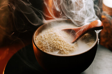 Couscous steaming in a wooden bowl with a spoon ready for serving
