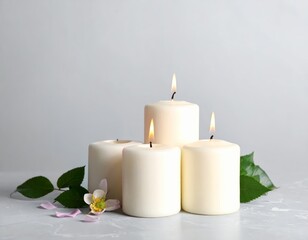 Candles and pink flowers arranged on a light surface create a calm and soothing atmosphere for relaxation or celebration