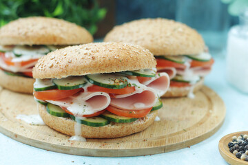 Bun sandwiches with salami and vegetables	