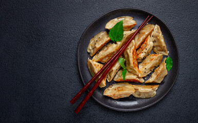 japanese fried gyoza dumplings, with pork, sesame seeds, green onions,
