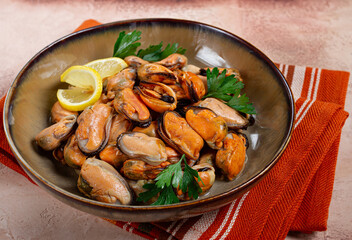 mussels no shell, boiled, mussels, peeled, in a bowl, with lemon and parsley, Chilean mussels, top view, no people,