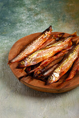 cold smoked capelin, on a wooden bowl, top view, no people,