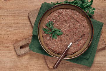 Red bean lobio,a traditional Georgian dish, on a wooden table, homemade,