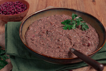 Red bean lobio,a traditional Georgian dish, on a wooden table, homemade,