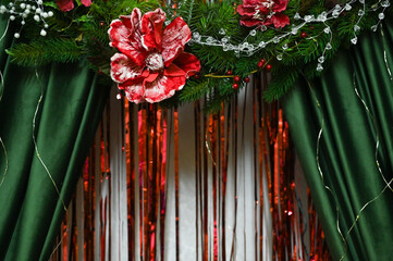artificial flowers on fabric composition. Floral arrangement with red flowers, colorful ribbons. harmonious, festive atmosphere. decorative setup featuring red flowers. abstract background