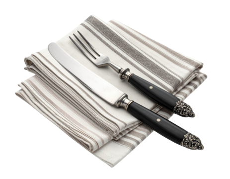 Elegant cutlery set on striped napkins