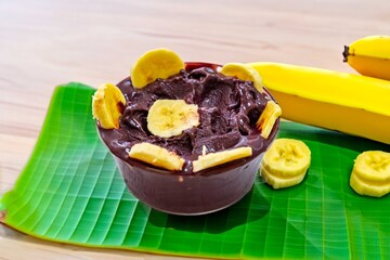 The most authentic Brazilian açaí, Euterpe oleracea, with banana in a minimalist bowl and compatible environment. Superfood energy and vitamins