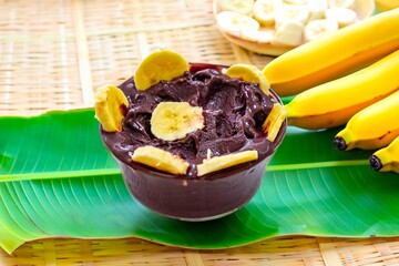 The most authentic Brazilian açaí, Euterpe oleracea, with banana in a minimalist bowl and compatible environment. Superfood energy and vitamins
