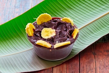 The most authentic Brazilian açaí, Euterpe oleracea, with banana in a minimalist bowl and compatible environment. Superfood energy and vitamins