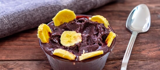 The most authentic Brazilian açaí, Euterpe oleracea, with banana in a minimalist bowl and compatible environment. Superfood energy and vitamins