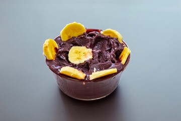 The most authentic Brazilian açaí, Euterpe oleracea, with banana in a minimalist bowl and compatible environment. Superfood energy and vitamins