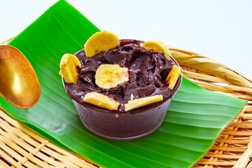 The most authentic Brazilian açaí, Euterpe oleracea, with banana in a minimalist bowl and compatible environment. Superfood energy and vitamins
