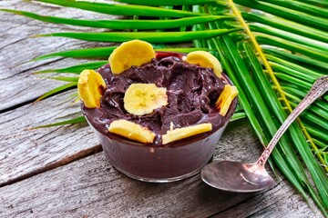 The most authentic Brazilian açaí, Euterpe oleracea, with banana in a minimalist bowl and compatible environment. Superfood energy and vitamins