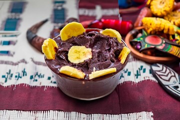 The most authentic Brazilian açaí, Euterpe oleracea, with banana in a minimalist bowl and compatible environment. Superfood energy and vitamins