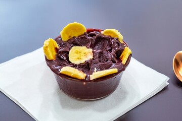The most authentic Brazilian açaí, Euterpe oleracea, with banana in a minimalist bowl and compatible environment. Superfood energy and vitamins