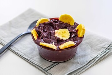 The most authentic Brazilian açaí, Euterpe oleracea, with banana in a minimalist bowl and compatible environment. Superfood energy and vitamins