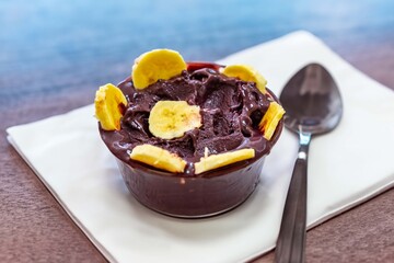 The most authentic Brazilian açaí, Euterpe oleracea, with banana in a minimalist bowl and compatible environment. Superfood energy and vitamins