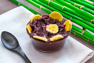 The most authentic Brazilian açaí, Euterpe oleracea, with banana in a minimalist bowl and compatible environment. Superfood energy and vitamins