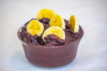 The most authentic Brazilian açaí, Euterpe oleracea, with banana in a minimalist bowl and compatible environment. Superfood energy and vitamins