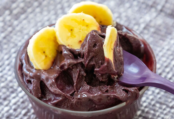The most authentic Brazilian açaí, Euterpe oleracea, with banana in a minimalist bowl and compatible environment. Superfood energy and vitamins
