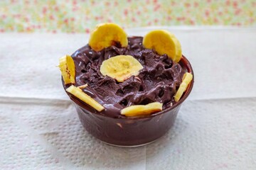 The most authentic Brazilian açaí, Euterpe oleracea, with banana in a minimalist bowl and compatible environment. Superfood energy and vitamins